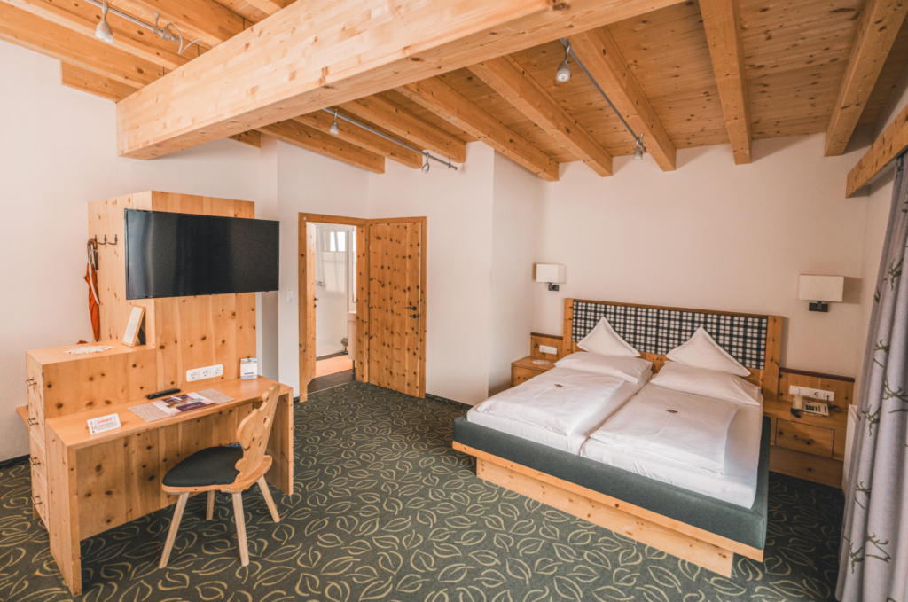 Bright and modern hotel room with wooden decor and two beds